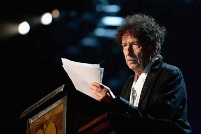 The hand that writes is not the hand that signs. Bob Dylan has to live with it